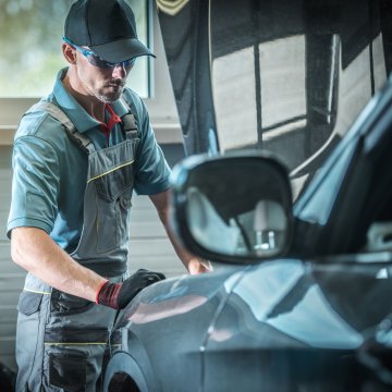 features toco vehicle service contracts provider mechanic checking out car 